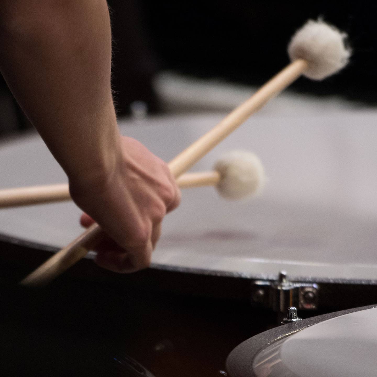 a close up of mallets beating a drum