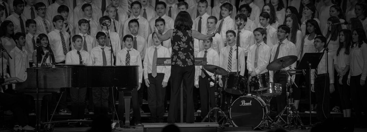 woman director conducting singing group