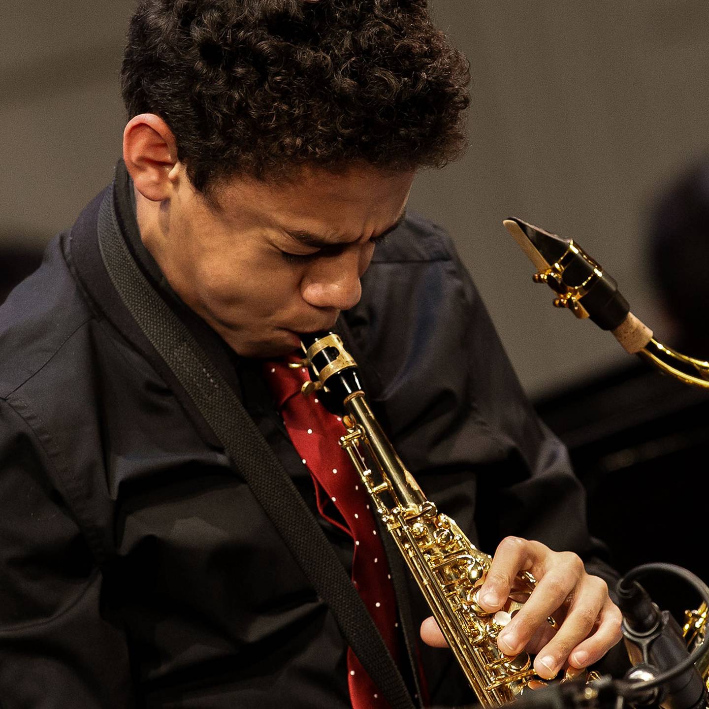 a close up of a man playing a saxaphone
